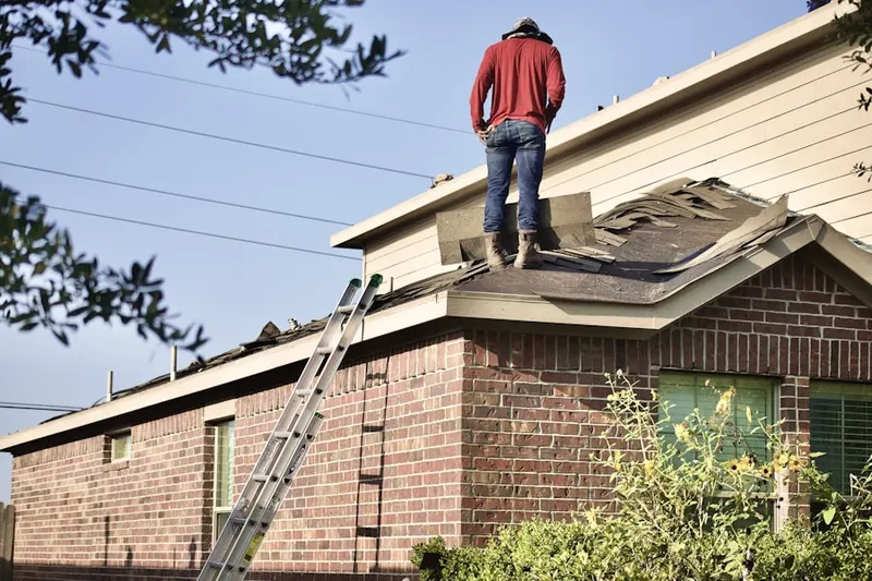 Professional roofer working on a residential roof in Stevens